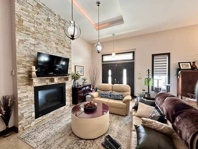 Living room with stone fireplace and seating
